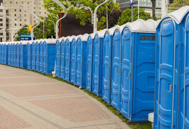 hygienic portable restrooms lined up at a music festival, providing comfort and convenience for attendees in Garden City